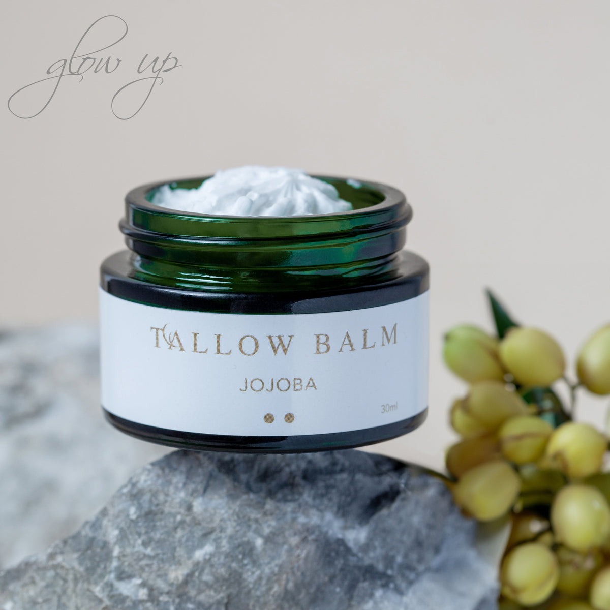 Tallow Balm Jojoba auf hellem Stein mit frischer Zitrusdeko im Hintergrund