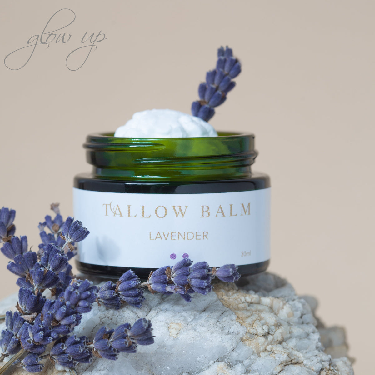 Tallow Balm Lavender vor beigem Hintergrund – umgeben von duftendem Lavendel